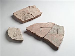 Fragment Roof Tile Impressed with Stamp-Seal Impression 
 Photographer:Meidad Suchowolski